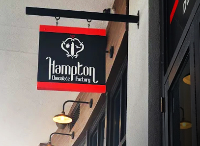 Image for the Visit HCF page of the sign in Tampa, Florida that says "Hampton Chocolate Factory" in Sparksman Wharf