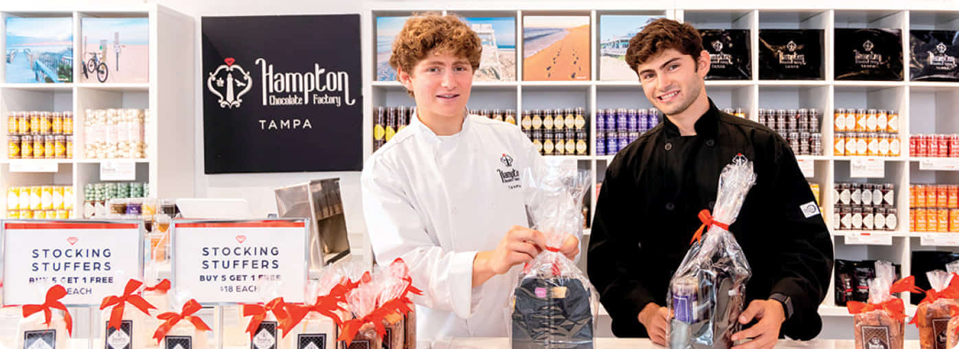 Grant Gappelberg and Austin Gappelberg with custom chocolate gifts in the tampa florida flagship location