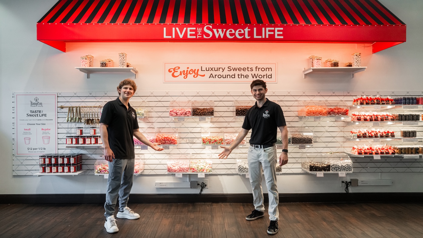 Colorful Swedish candy pick and mix display wall featuring various spring-themed gummies, marshmallows, and chocolates in clear bins.